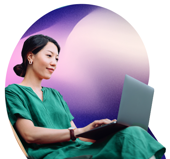 A dark haired lady looks at a laptop screen