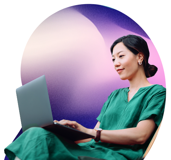 A dark haired lady looks at a laptop screen