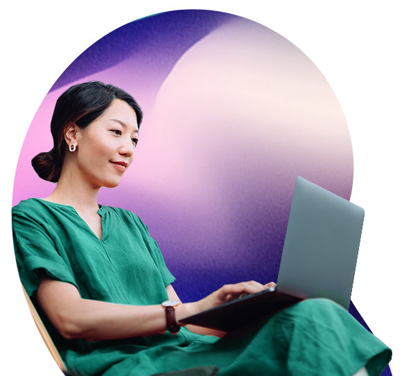 A dark haired lady looks at a laptop screen