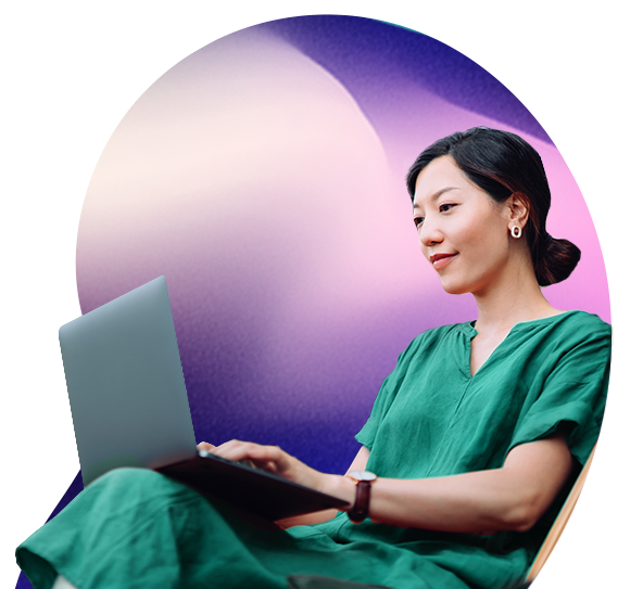 A dark haired lady looks at a laptop screen